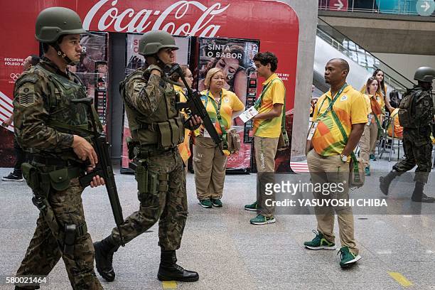 Brazilian Air Force personnel stand guard at the arrival level of the Galeao International airport in Rio de Janeiro, Brazil, on July 25, 2016....