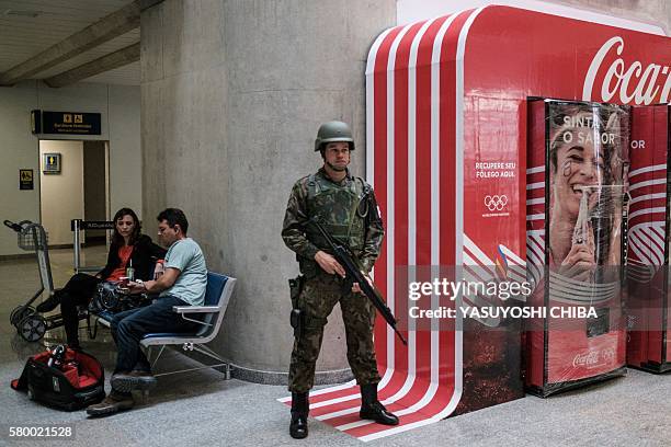 Brazilian Air Force personnel stand guard at the arrival level of the Galeao International airport in Rio de Janeiro, Brazil, on July 25, 2016....