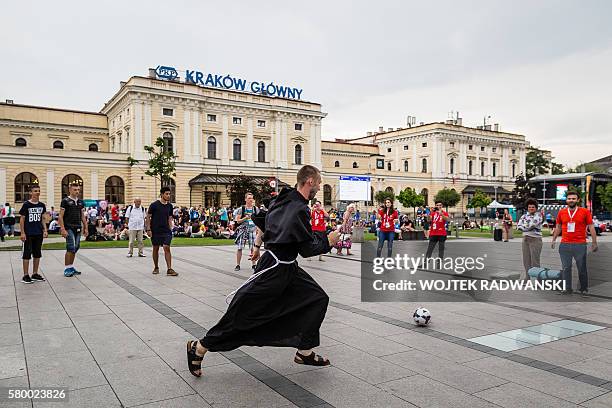 Young people and a monk play soccer in front of the main railway station in Krakow, Poland, on July 25 one day ahead of the official opening of the...