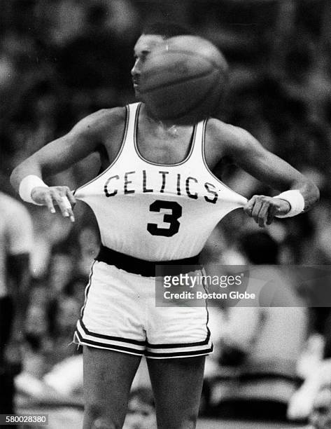 Boston Celtics player Dennis Johnson puts on his jersey, during a game against the Milwaukee Bucks at the Boston Garden on March 26, 1986.