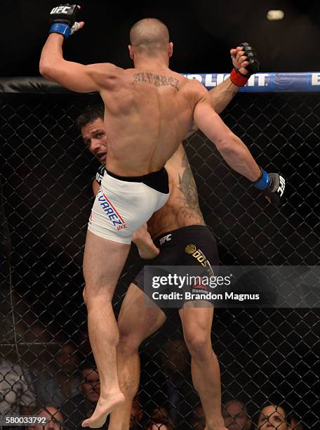 Eddie Alvarez knees Rafael Dos Anjos of Brazil in their lightweight championship bout during the UFC Fight Night event inside the MGM Grand Garden...