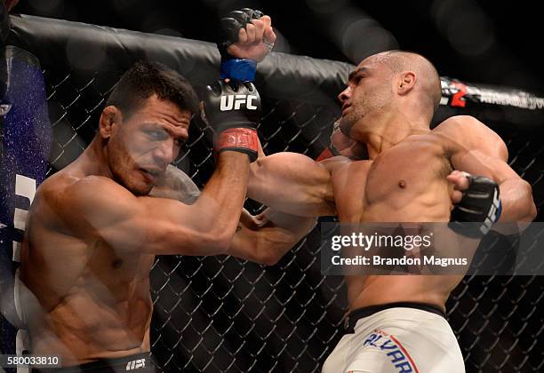 Eddie Alvarez punches Rafael Dos Anjos of Brazil in their lightweight championship bout during the UFC Fight Night event inside the MGM Grand Garden...