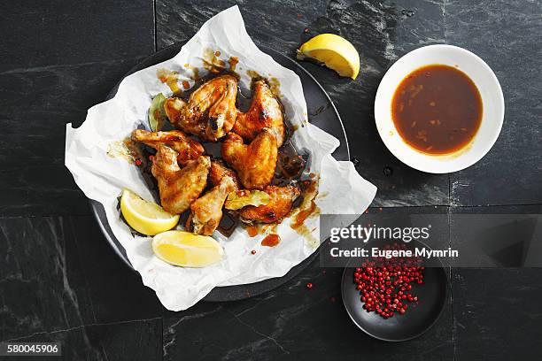 barbecue chicken wings with orange and maple sauce - chicken wings plate stock pictures, royalty-free photos & images