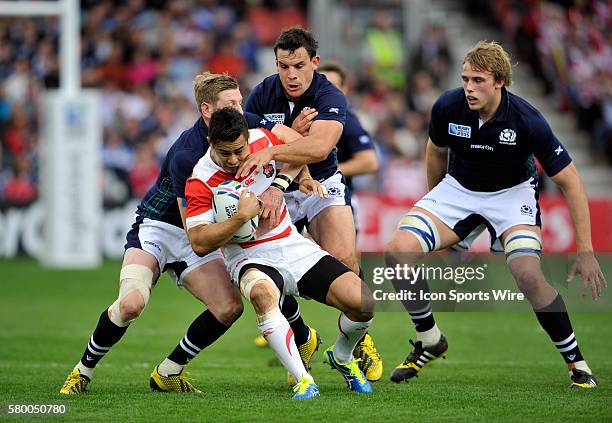 Japan's Yu Tamura is tackled by Scotland's Finn Russell during the 2015 Rugby World cup being held at Kingsholm in Gloucester, UK. Scotland would...