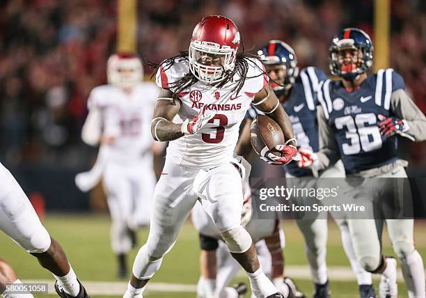 Arkansas Razorbacks running back Alex Collins carries for a first down on a wild 4th and 25 yard play during an NCAA football game between the Ole...