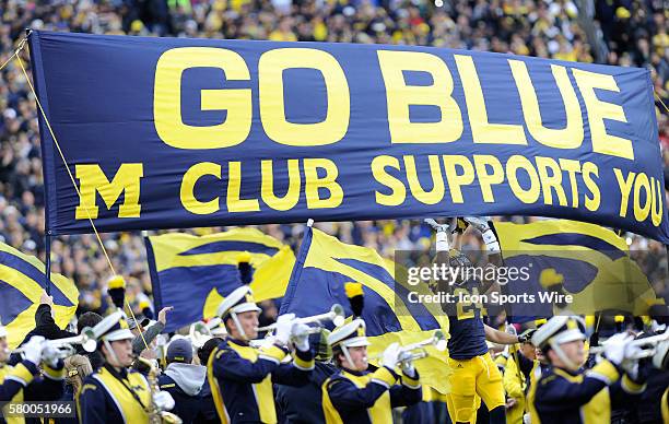 Saturday, November 7, 2015: Michigan players run out onto the field before the Michigan Wolverines 49-16 win over the Rutgers Scarlet Knights at...