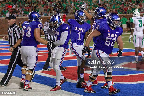 Mustangs players including wide receiver Kevin Thomas , offensive lineman Evan Brown and offensive lineman Taylor Lasecki celebrate a touchdown by...
