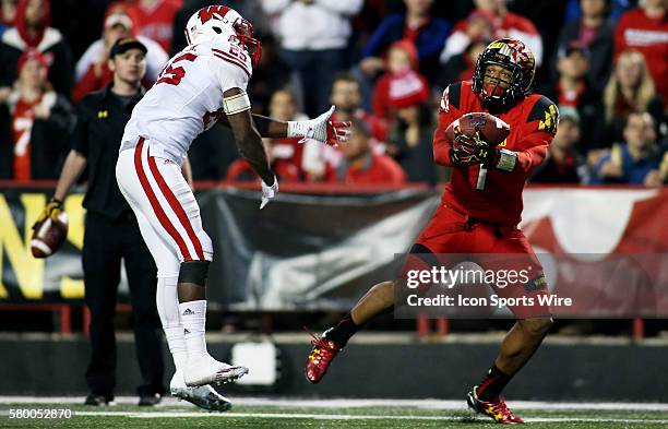 Maryland Terrapins wide receiver D.J. Moore hauls in a catch over Wisconsin Badgers cornerback Derrick Tindal during a match between the University...