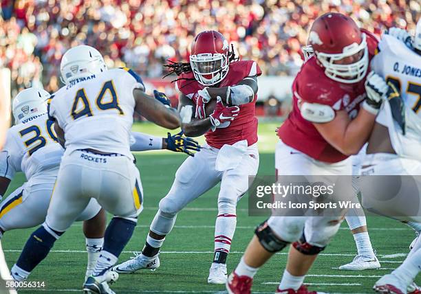 Arkansas Razorbacks running back Alex Collins looks for room to run against the Toledo Rocket defense during the Toledo versus University of Arkansas...