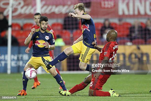 New York Red Bulls midfielder Dax McCarty battles for the ball against Toronto FC midfielder Collen Warner at BMO Field in Toronto, Ontario, CAN.