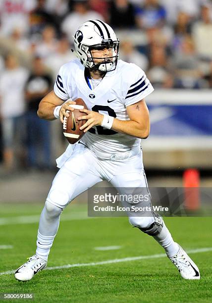Brigham Young Cougars quarterback Tanner Mangum scrambles and throws a touchdown pass during a game between Boise State and BYU. Boise State leads at...