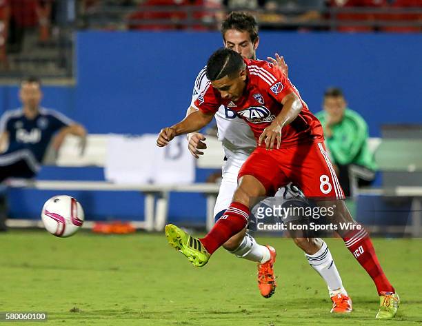 Dallas Victor Ulloa tries to elude Whitecaps Octavio Rivero during the MLS game between the Vancouver Whitecaps FC and FC Dallas at Toyota Stadium in...