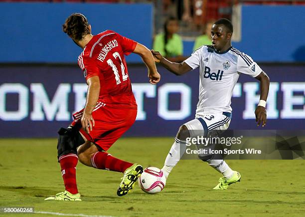 Vancouver Whitecaps Kekuta Manneh tries to go around FC Dallas Ryan Hollingshead during the MLS game between the Vancouver Whitecaps FC and FC Dallas...