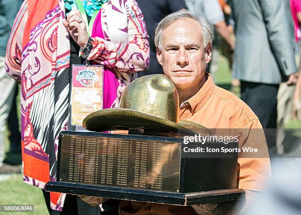 Texas Longhorns players are presented the trophy by Governor Abbot after winning the Red River Showdown after the Texas Longhorns victory over the...