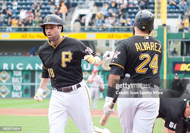 Pittsburgh Pirates second baseman Neil Walker is greeted by first baseman Pedro Alvarez after hitting a solo home run during the second inning in the...