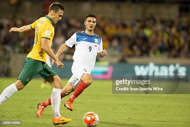 Islam Shamshiev of Kyrgyzstan marks an Australian defender during the Asia Group FIFA 2018 World Cup qualifying game played at the GIO Stadium in...