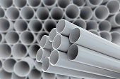 PVC pipes stacked in warehouse.