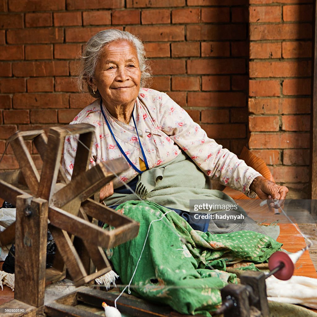 Nepali woman spinning the wool in Bhaktapur
