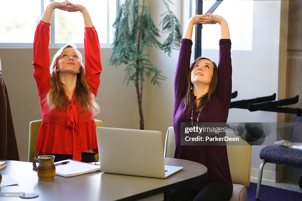 Students or Young Business Women Doing Yoga Stretching Working Studying