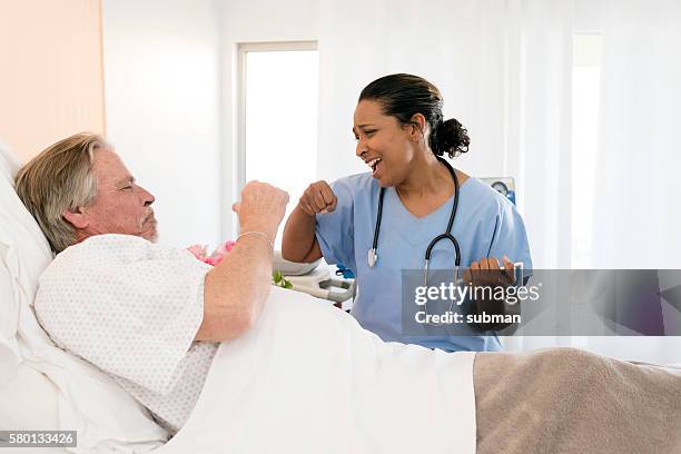 senior man in hospital bed - doctor humor stock pictures, royalty-free photos & images