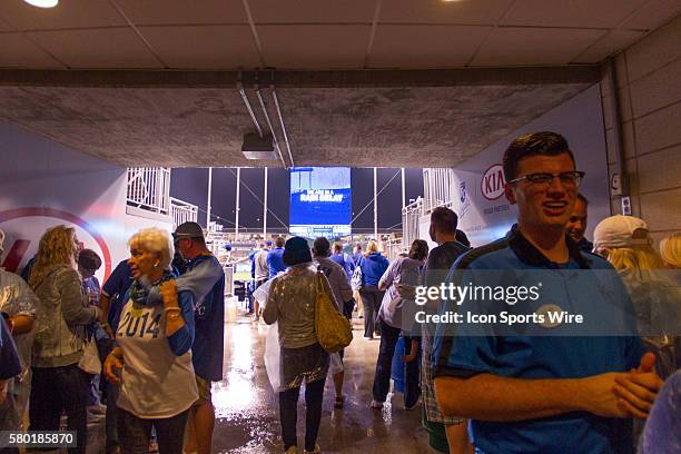 Kansas City Royals fans take refuge during a rain delay in the middle of the MLB Playoff ALDS game 1 between the Houston Astros and the Kansas City...