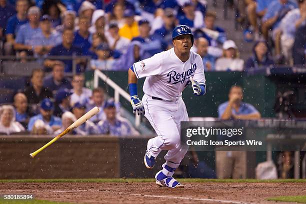 Kansas City Royals catcher Salvador Perez heads to first base as he watches a pop fly in the rain during the MLB Playoff ALDS game 1 between the...