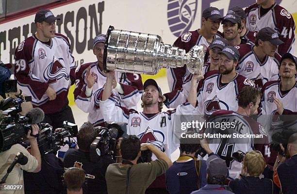 Peter Forsberg of the Colorado Avalanche holds up the Stanley Cup after defeating the New Jersey Devils in game seven of the NHL Stanley Cup Finals...