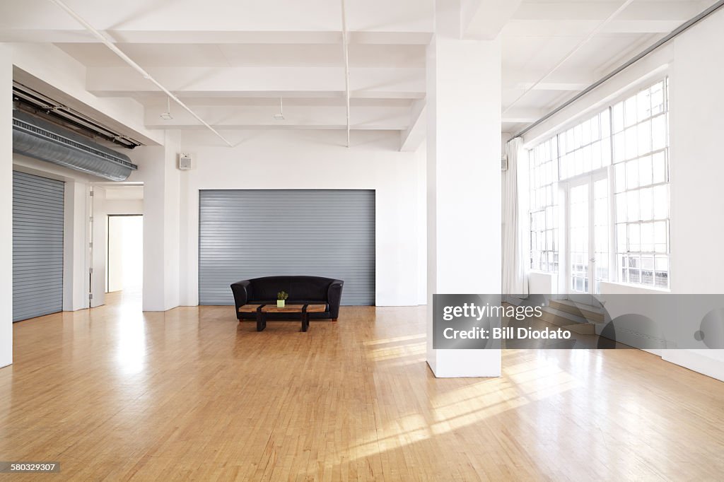 Large bare room with couch