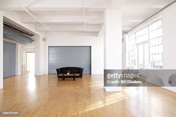 large bare room with couch - tidy room stock pictures, royalty-free photos & images