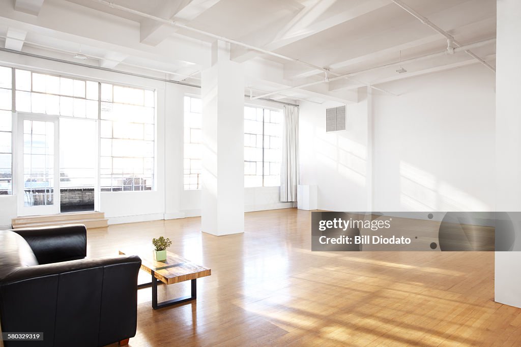 Alternate view of large bare room with couch