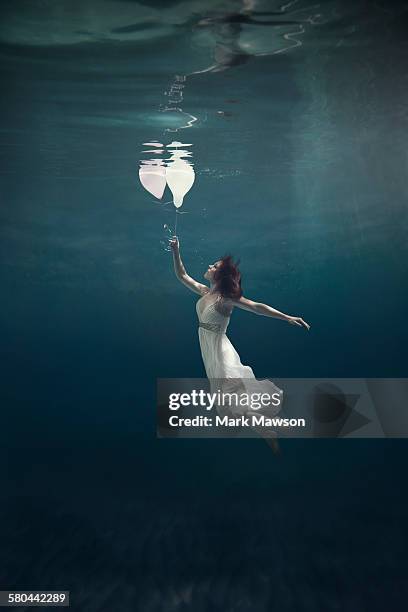 girl underwater with balloons - floating on water stock pictures, royalty-free photos & images