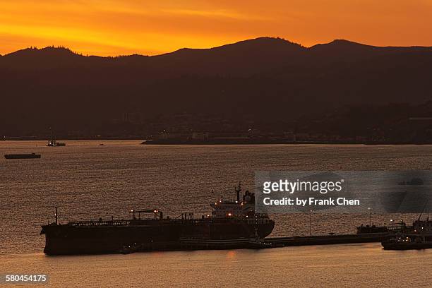 oil terminal after sunset, sf bay - gaston richmond stock-fotos und bilder