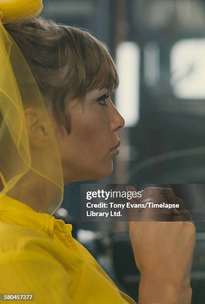 English model Pattie Boyd filming a commercial for Dop Pearlized Shampoo by L'Oreal, UK, 1966.