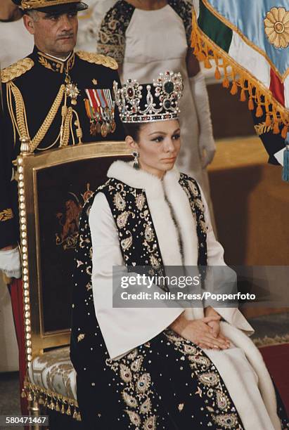 View of Queen of Iran, Farah Pahlavi sitting on a throne chair during the coronation ceremony of her husband, Mohammad Reza Pahlavi as Shah of Iran...