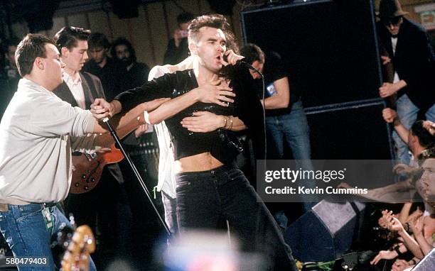 Fans invade the stage during the first solo concert by English singer and lyricist Morrissey after the break-up of The Smiths, at Wolverhampton Civic...