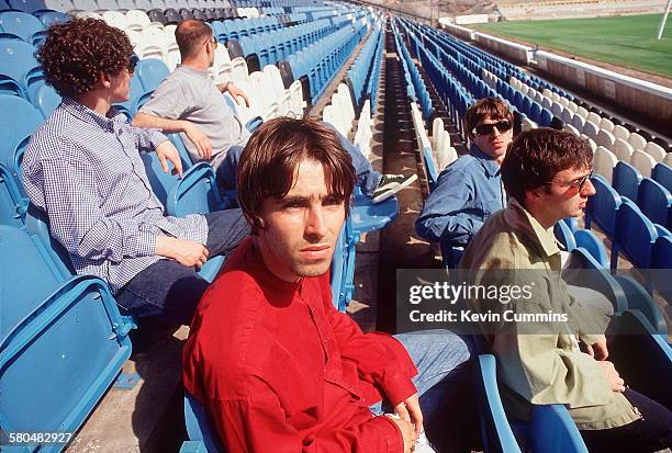 British rock band Oasis, at Manchester City's Maine Road stadium, Manchester, 2nd August 1994. Left to right: drummer Tony McCarroll, rhythm...