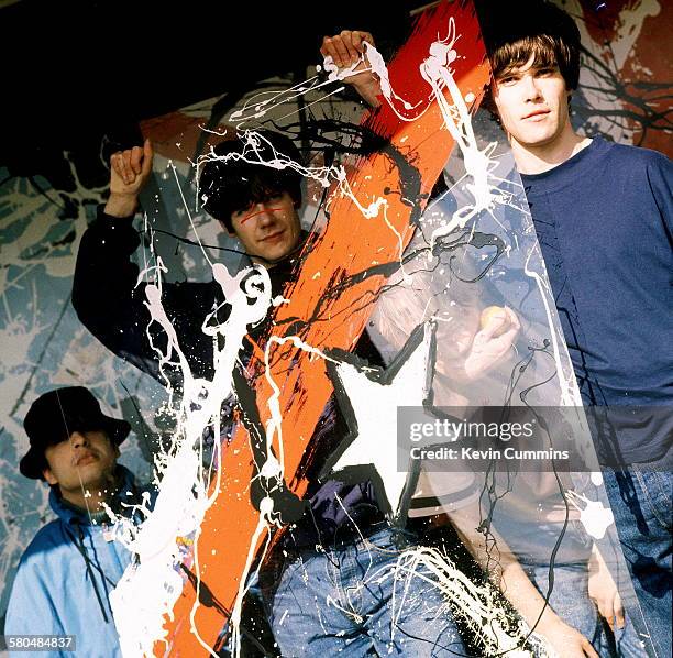 English rock group The Stone Roses holding a painted sheet of clear plastic, 8th May 1989. Left to right; drummer Alan 'Reni' Wren, guitarist John...