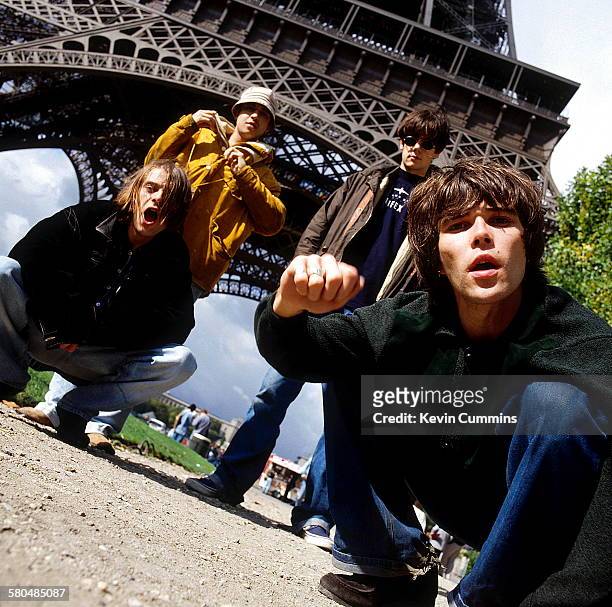 English rock group The Stone Roses at the foot of the Eiffel Tower, Paris, 9th October 1989. Left to right: bassist Gary 'Mani' Mounfield, drummer...