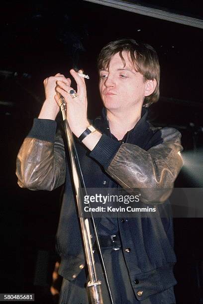 Singer and lyricist Mark E Smith performing with English rock group, The Fall, circa 1989.