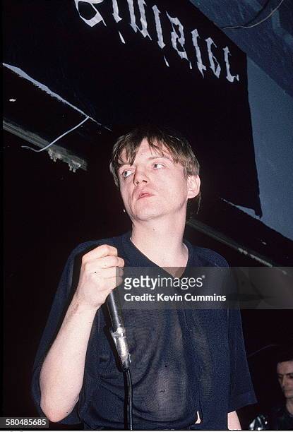 Singer and lyricist Mark E Smith performing with English rock group, The Fall, circa 1989.