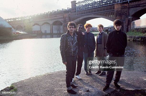 British soul and pop group, Simply Red, by a canal in Manchester, 1985. Left to right: guitarist Dave Fryman, keyboard player Fritz McIntyre, bassist...