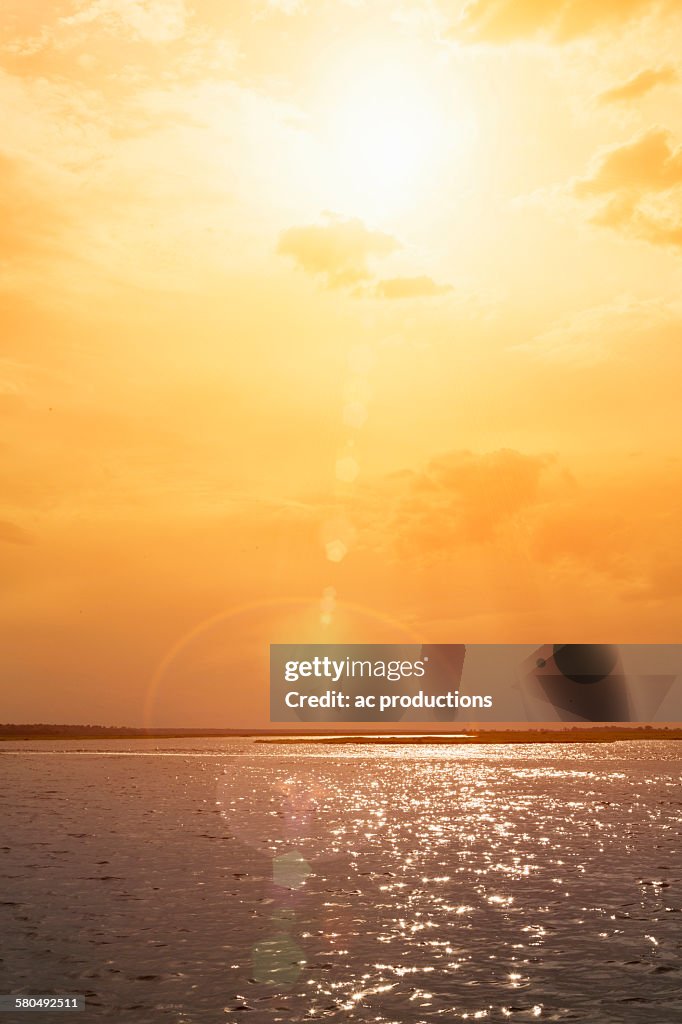 Sunset over rippling ocean water