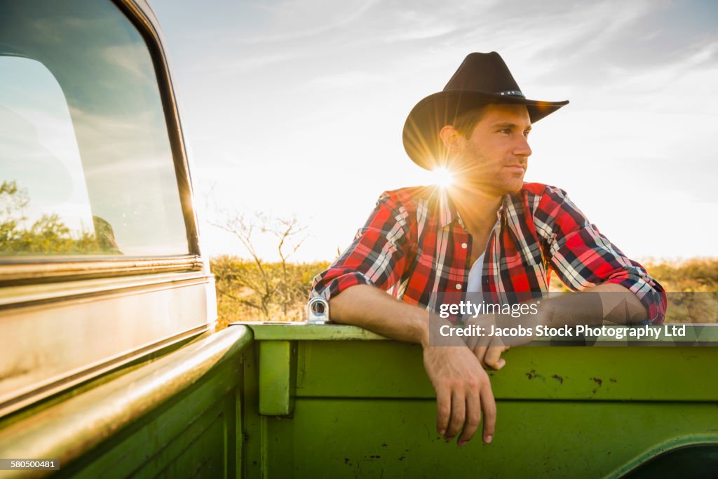 Caucasian man leaning on truck outdoors