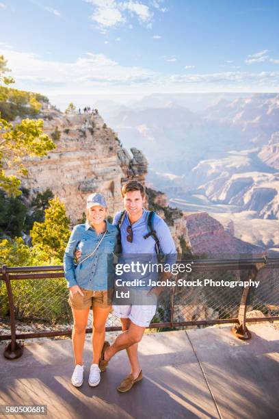 caucasian couple smiling in grand canyon, arizona, united states - couple grand canyon stock pictures, royalty-free photos & images