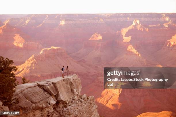 caucasian man photographing grand canyon, arizona, united states - grand canyon national park stock pictures, royalty-free photos & images