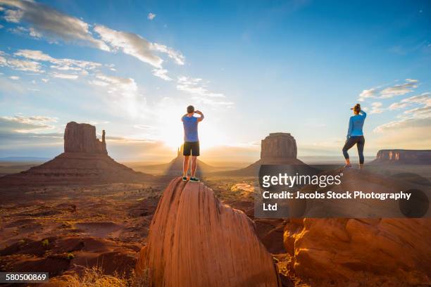 caucasian couple admiring monument valley, utah, united states - utah landscape stock pictures, royalty-free photos & images