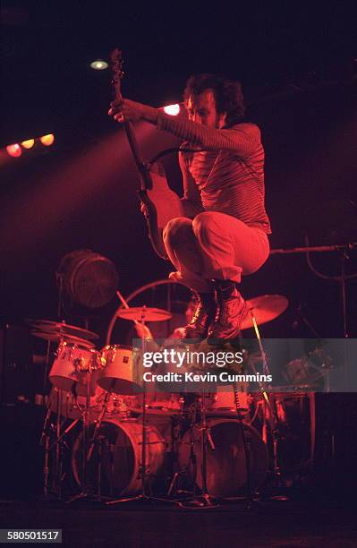 Guitarist Pete Townshend performing with English rock group The Who at Belle Vue, Manchester, October 1975. In the background is Drummer Keith Moon .