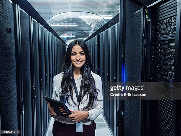 mixed race technician holding digital tablet in server room - utah stock photos et images de collection