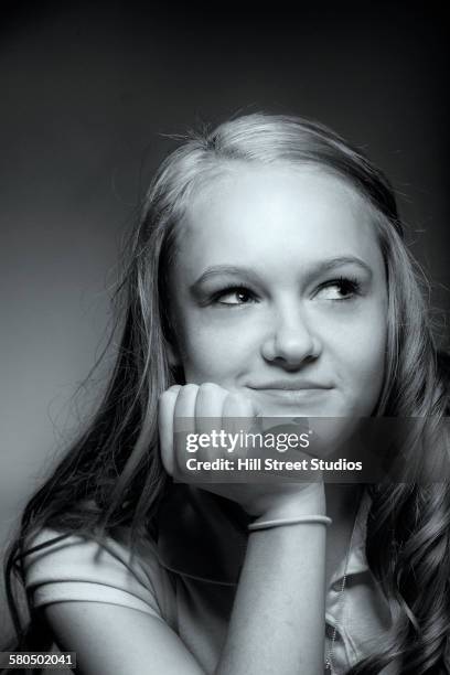 caucasian girl resting chin in hand - 12 year old blonde girl stock pictures, royalty-free photos & images