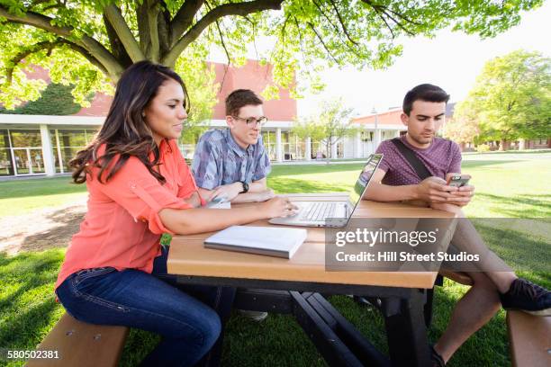 students using laptop on college campus - profile laptop sitting stock pictures, royalty-free photos & images